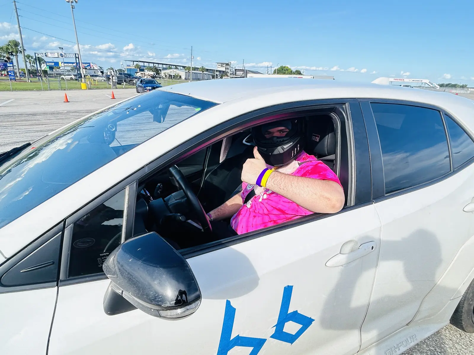 Driver seated in a white competition car