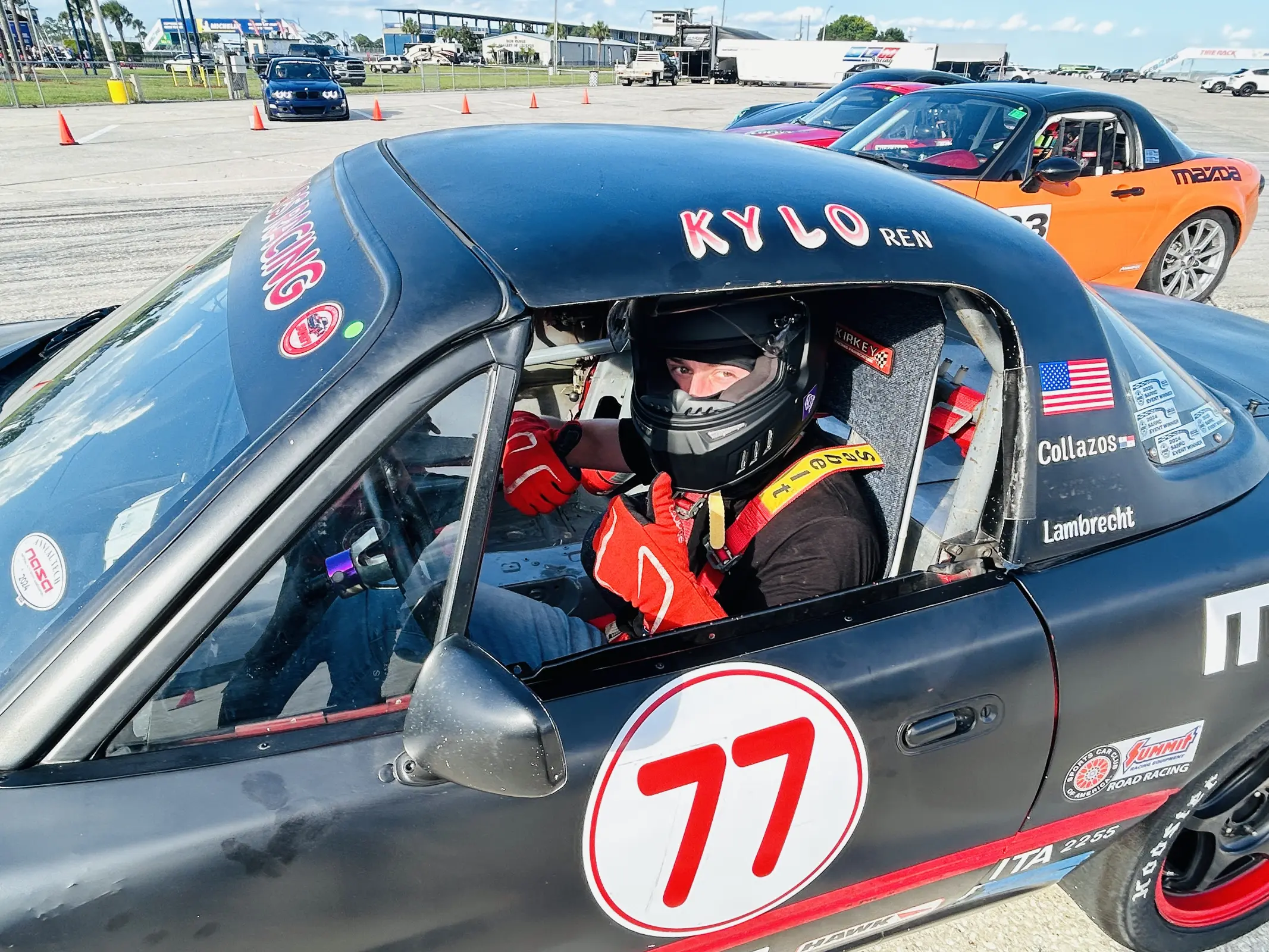 Helmeted driver in the number 77 Collegiate Racing Series car
